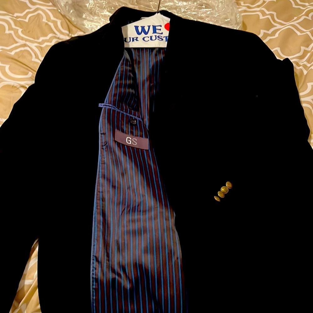 Very dark blue suit jacket, lined and striped inside. Two buttons down